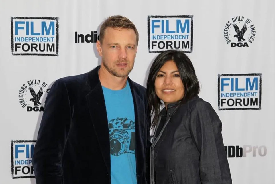 A man and a woman at the press wall of the Film Independent Forum.
